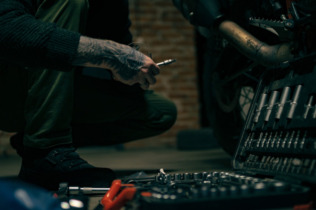 a-man-sitting-on-the-ground-with-a-cigarette-in-his-hand-pc7te-28los