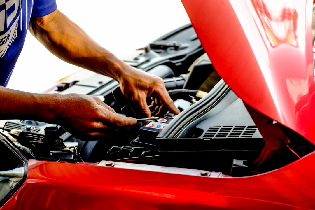 person-fixing-car-during-daytime-c2zr3x1zwwg